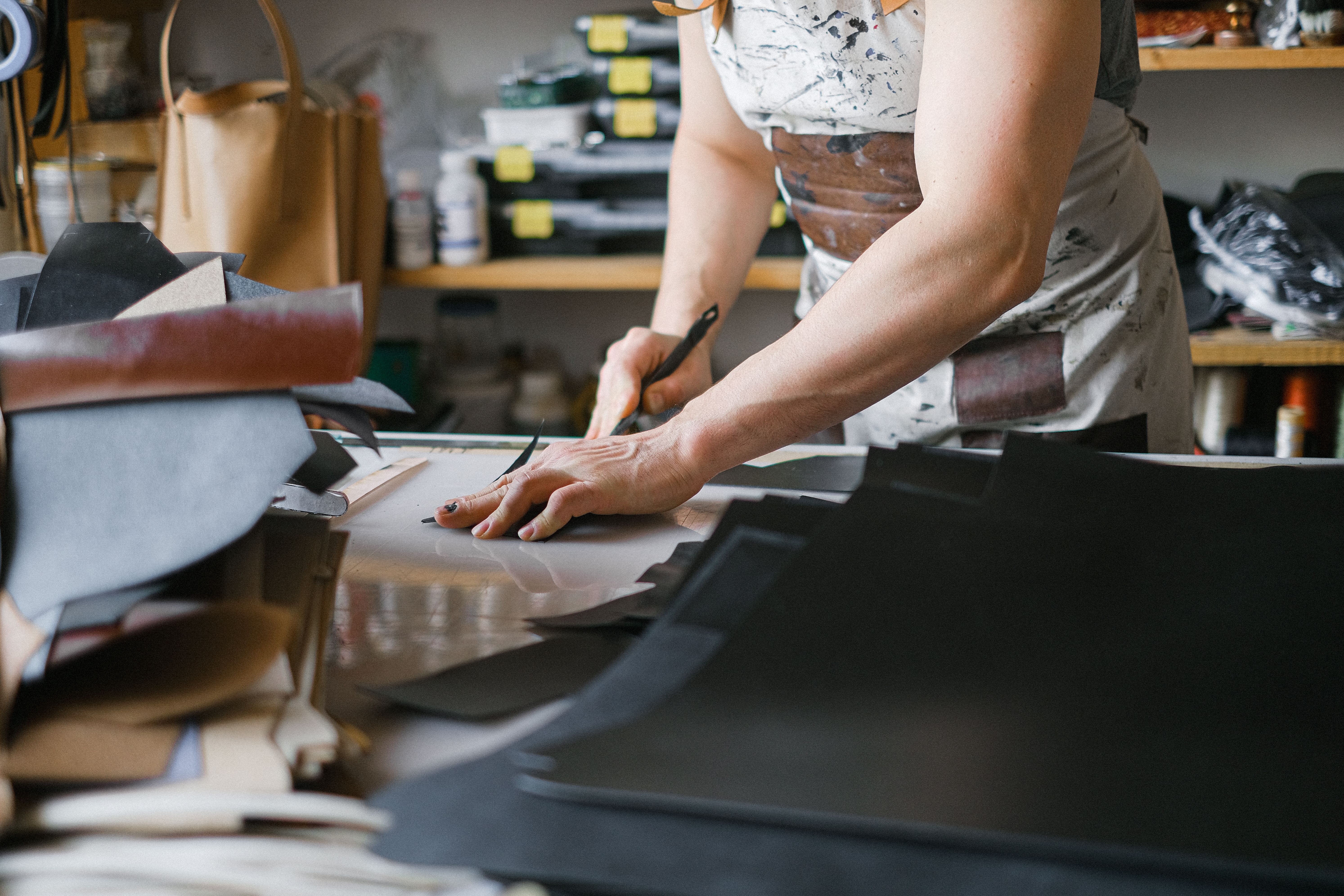 Master artisan finishing a premium leather product